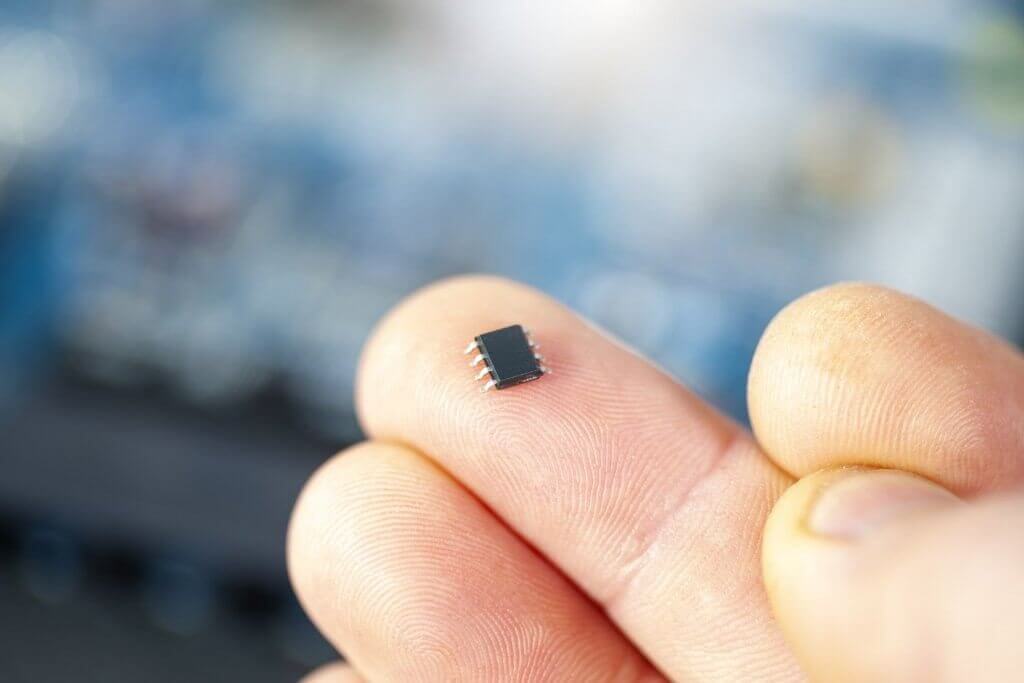 chip de nanotecnologia em contraste com um dedo